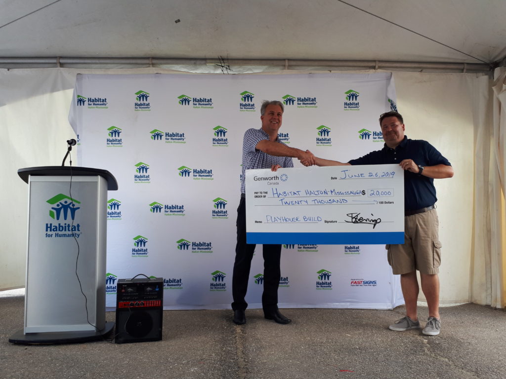 A $20,000 cheque presented by Genworth Canada to Habitat HM.