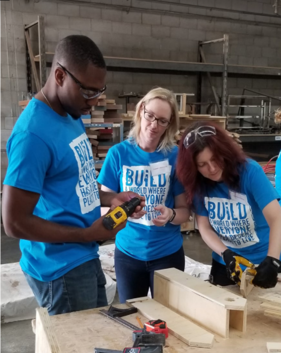Corporate team or Group volunteers crafting wood pieces into upcycled or revived woodcraft items at Habitat HMD's ReVive Centre