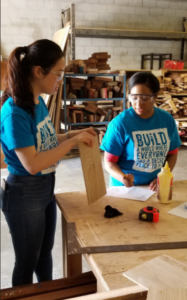 Group volunteers crafting wood pieces into upcycled or revived woodcraft items at Habitat HMD's ReVive Centre