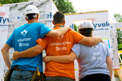 Teamwork picture of a Habitat for Humanity staff, construction team member and a volunteer, while at a home build site