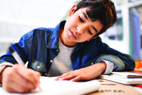 Image of a young boy doing his homework
